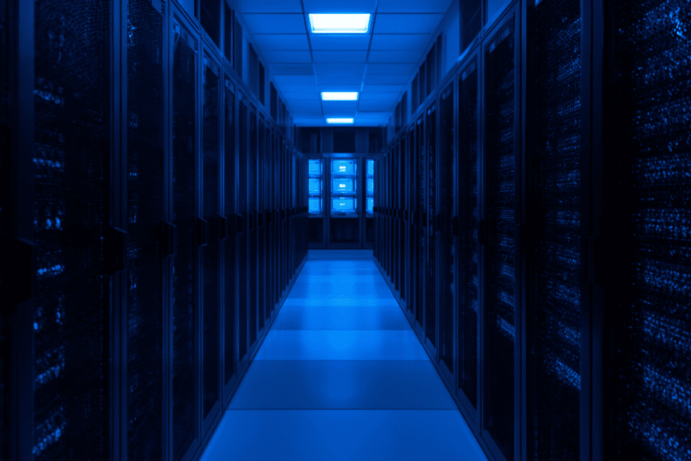 A modern server room illuminated in blue, representing secure data environments enhanced by machine-learning-driven cyber defense.