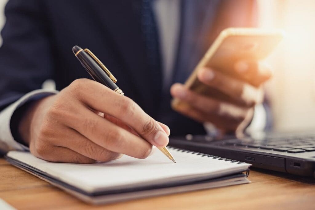 Person holding phone with checklist for opting out of data tracking